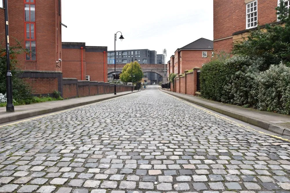 An street where cobblestones are beautifully etched on a road